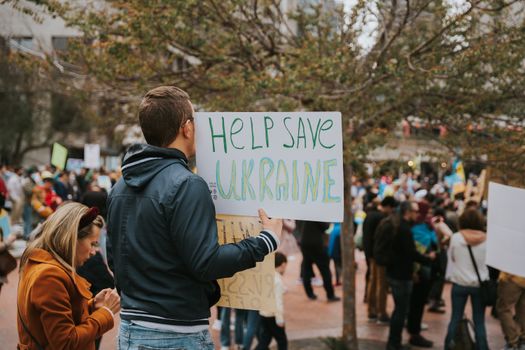 A peace rally in San Francisco with protesters holding signs supporting Ukraine.