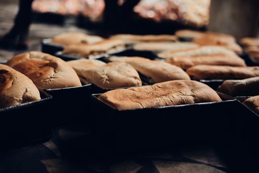 Freshly baked bread loaves cooling in a bakery with a warm, inviting atmosphere.