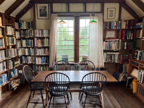 Charming library room with bookshelves and wooden table, perfect for study and research.