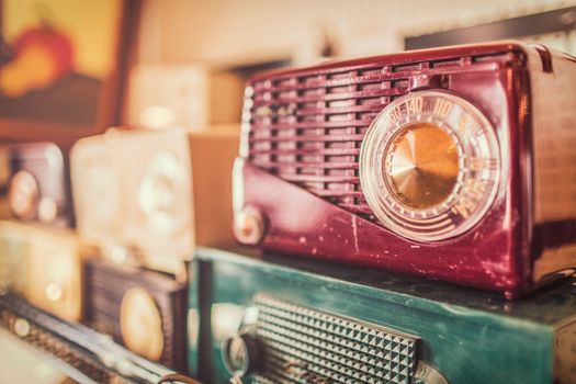 Close-up of retro radios showcasing vintage design with a warm, nostalgic tone.